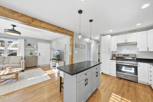 352 Leonard Rd, Louisburg, NC 27549 - kitchen with under cabinet range hood, beamed ceiling, light wood-type flooring, radiator heating unit, and stainless steel gas range