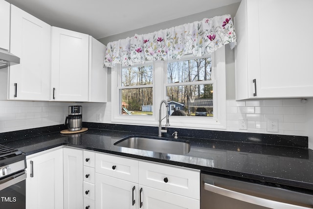 352 Leonard Rd, Louisburg, NC 27549 - kitchen featuring tasteful backsplash, dark stone counters, appliances with stainless steel finishes, white cabinetry, and a sink
