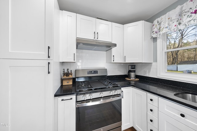 352 Leonard Rd, Louisburg, NC 27549 - kitchen featuring under cabinet range hood, decorative backsplash, stainless steel gas range, and white cabinetry