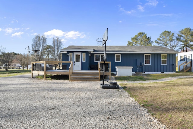 352 Leonard Rd, Louisburg, NC 27549 - ranch-style house featuring a deck, gravel driveway, and board and batten siding