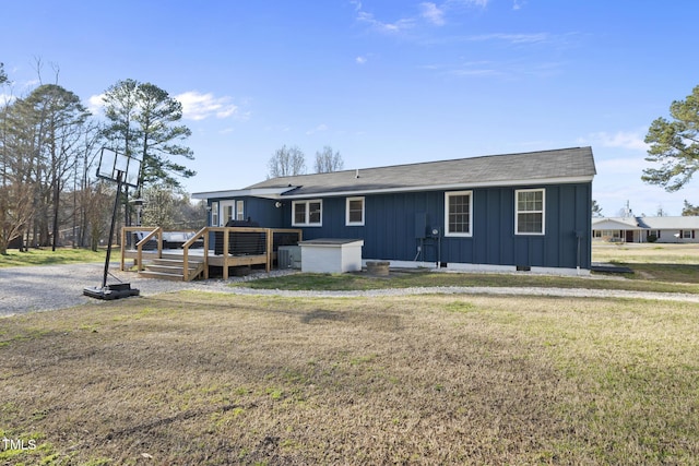 352 Leonard Rd, Louisburg, NC 27549 - back of property with a deck, board and batten siding, and a yard