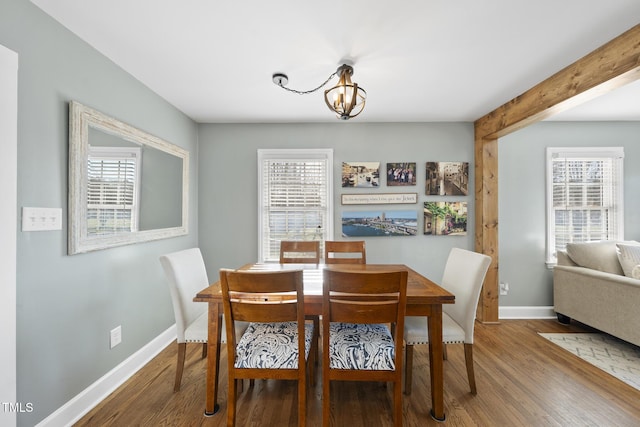 352 Leonard Rd, Louisburg, NC 27549 - dining room with an inviting chandelier, beamed ceiling, wood finished floors, and baseboards