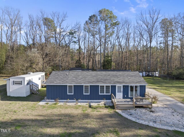 352 Leonard Rd, Louisburg, NC 27549 - view of front facade featuring a deck, a front yard, and a forest view