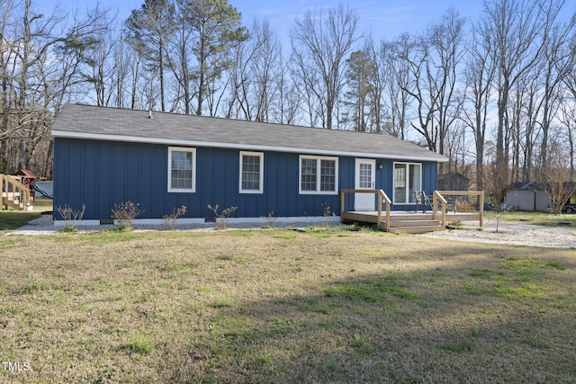 352 Leonard Rd, Louisburg, NC 27549 - view of front facade featuring crawl space, board and batten siding, a wooden deck, and a front yard