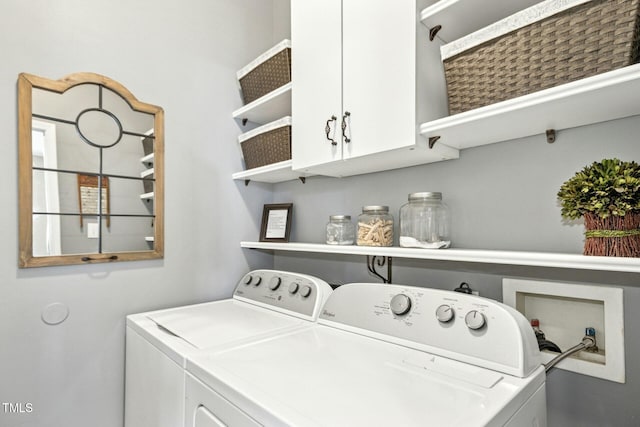 laundry room with cabinet space and washing machine and clothes dryer