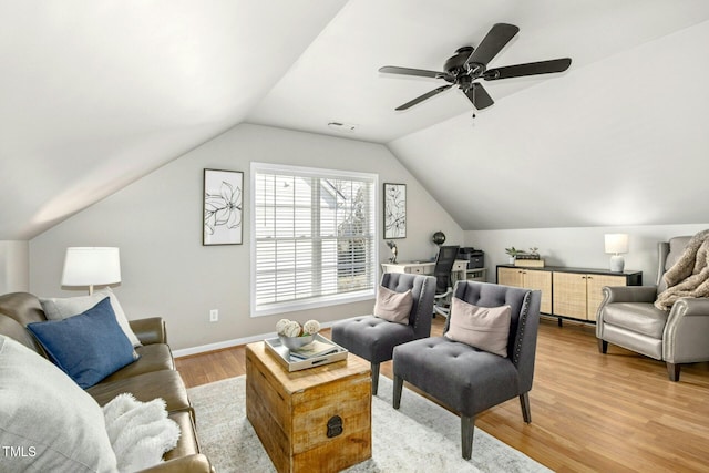 living area featuring light wood-type flooring, ceiling fan, baseboards, and vaulted ceiling