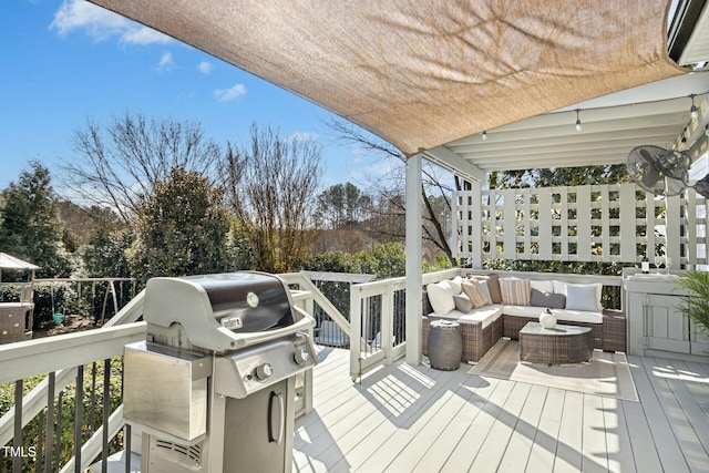 wooden deck with a grill and an outdoor hangout area