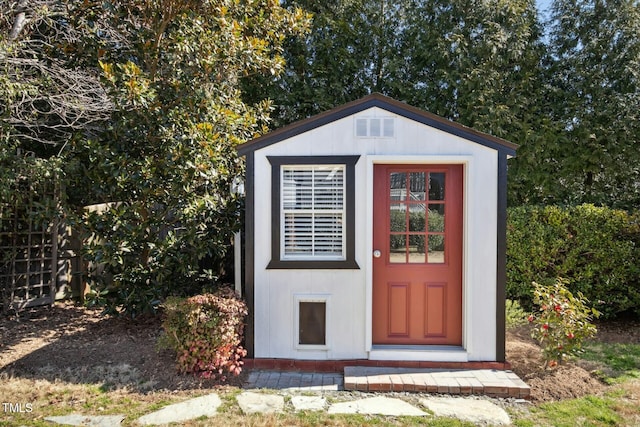 view of shed featuring fence