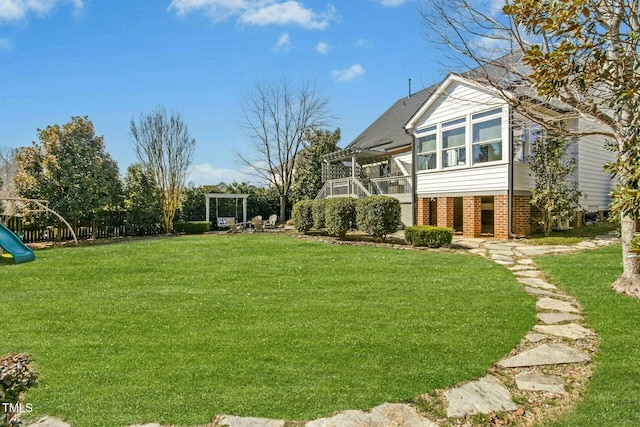 view of yard with a playground, a sunroom, and a pergola