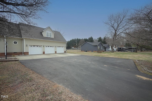 view of home's exterior featuring crawl space, driveway, and a lawn