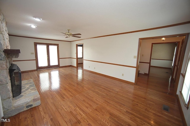 unfurnished living room featuring ornamental molding, french doors, visible vents, and light wood-style flooring