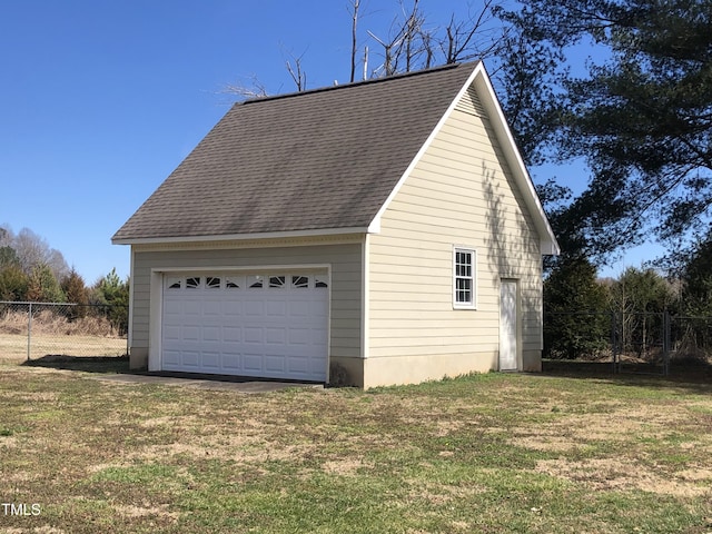 detached garage featuring fence