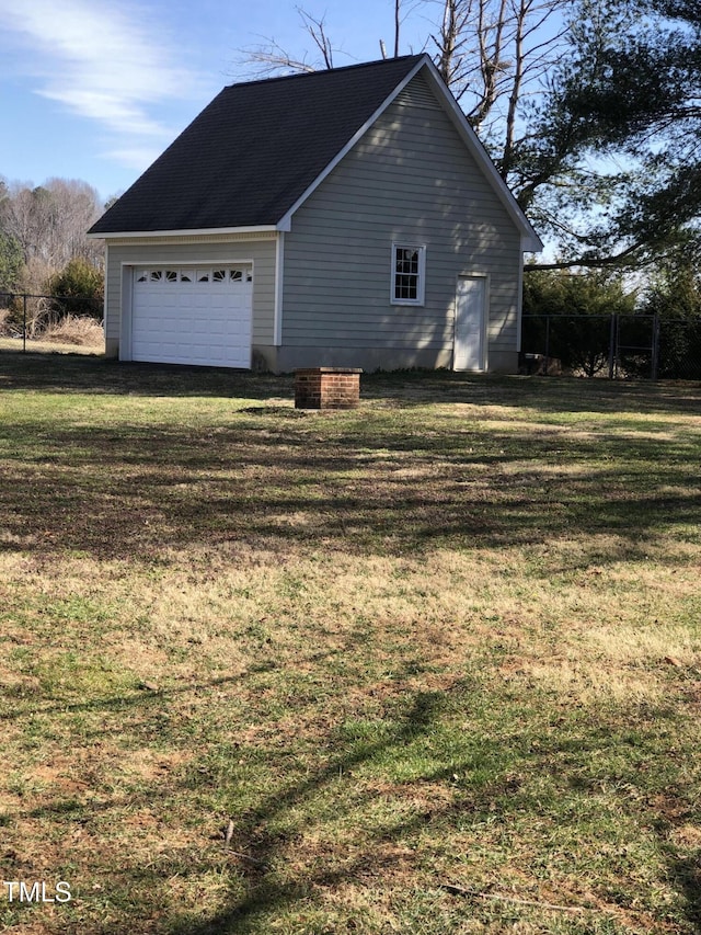 view of side of home with a yard and fence