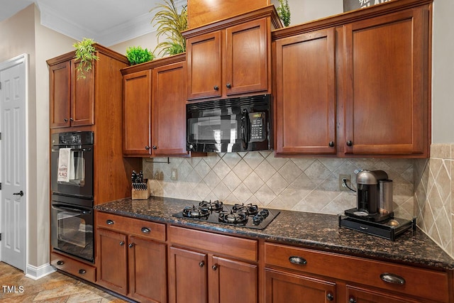 kitchen featuring ornamental molding, decorative backsplash, dark stone counters, black appliances, and brown cabinetry