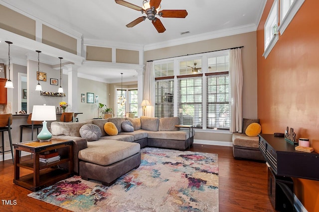 living area featuring a ceiling fan, crown molding, decorative columns, and wood finished floors