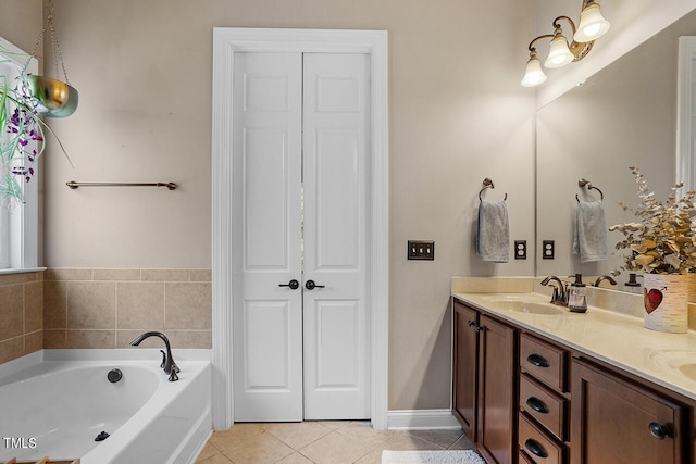 bathroom featuring double vanity, baseboards, tile patterned floors, a garden tub, and a sink