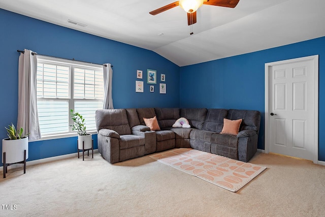 carpeted living area featuring lofted ceiling, visible vents, a ceiling fan, and baseboards