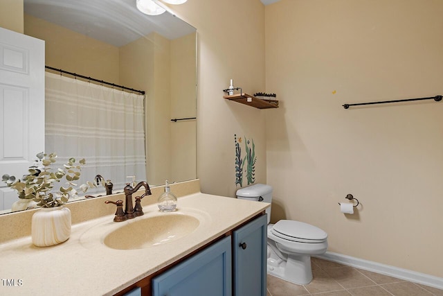 bathroom with toilet, baseboards, vanity, and tile patterned floors