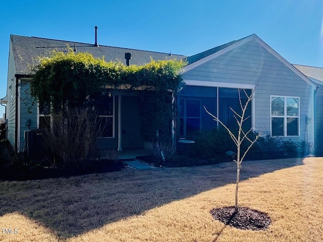 back of property featuring a lawn