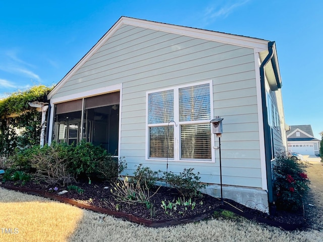 view of side of property with a sunroom