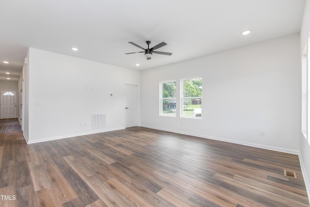 unfurnished room featuring dark wood-style floors, baseboards, visible vents, and recessed lighting