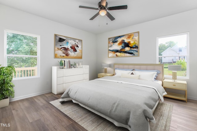 bedroom with a ceiling fan, light wood-style flooring, and baseboards