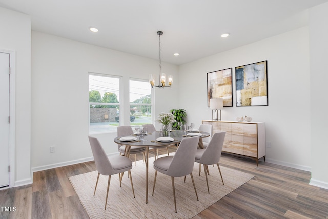 dining area with recessed lighting, a notable chandelier, baseboards, and wood finished floors