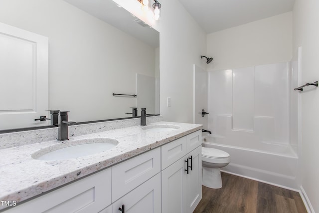 full bathroom featuring double vanity, wood finished floors, shower / bath combination, and a sink