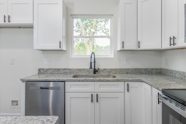 kitchen with white cabinetry, dishwasher, a sink, and light stone countertops