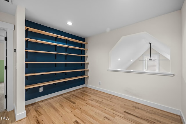 empty room with baseboards, visible vents, a ceiling fan, wood finished floors, and recessed lighting