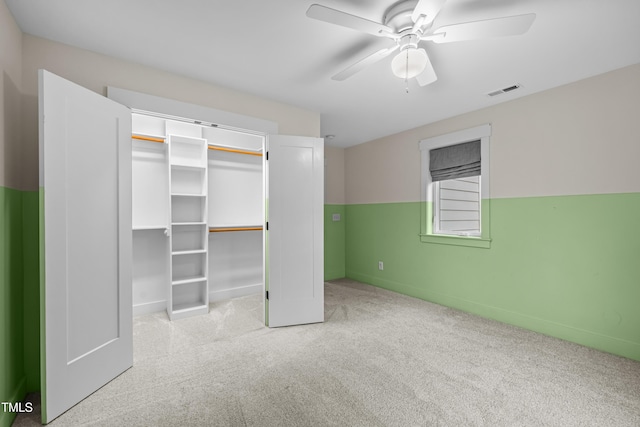 unfurnished bedroom featuring a ceiling fan, carpet, a closet, and visible vents