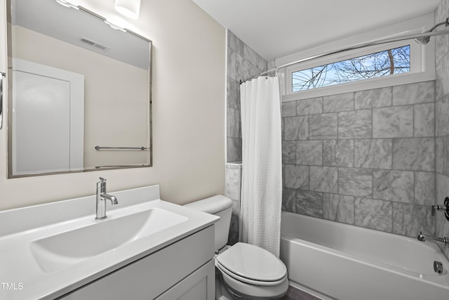 full bath with visible vents, vanity, toilet, and shower / bathtub combination with curtain