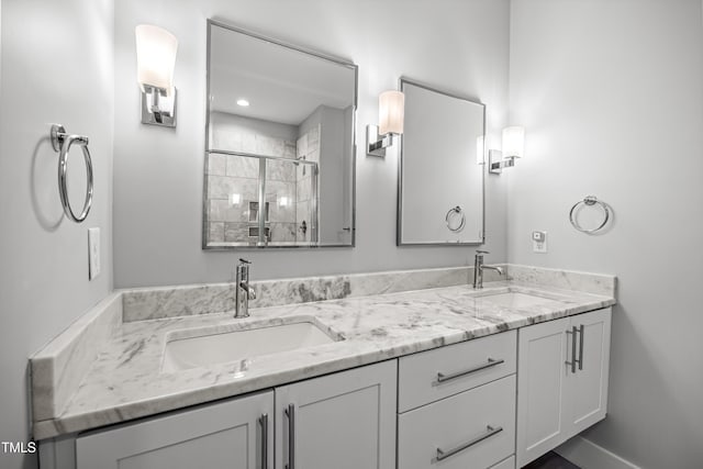 bathroom with double vanity, a sink, and a shower stall