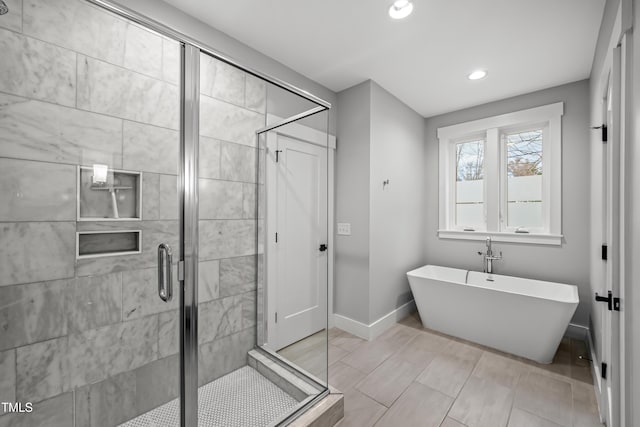 full bath with recessed lighting, a soaking tub, a shower stall, and baseboards