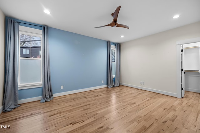 unfurnished room featuring light wood-type flooring, baseboards, and recessed lighting