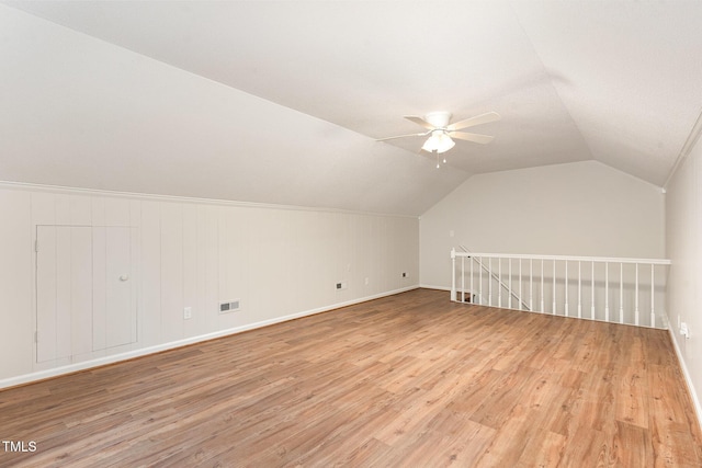 bonus room with visible vents, light wood-type flooring, a ceiling fan, and vaulted ceiling