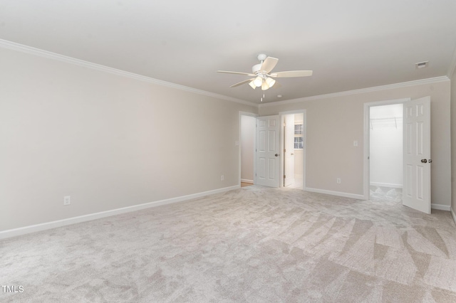 unfurnished room featuring crown molding, light colored carpet, and baseboards