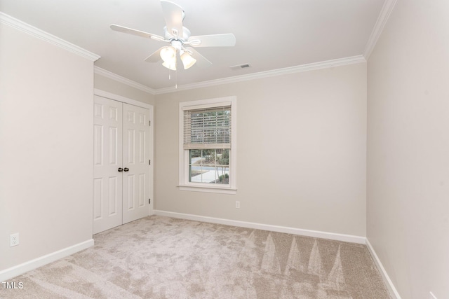 unfurnished bedroom featuring visible vents, crown molding, and carpet