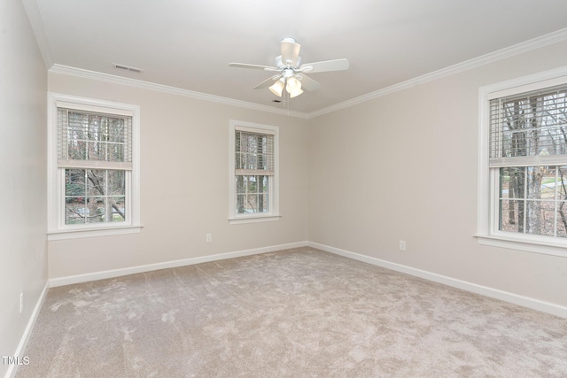 carpeted empty room featuring visible vents, baseboards, and ornamental molding