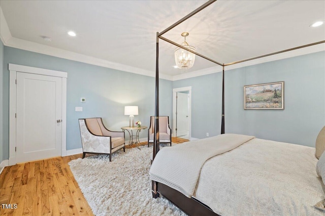 bedroom featuring light wood finished floors, baseboards, ornamental molding, and recessed lighting