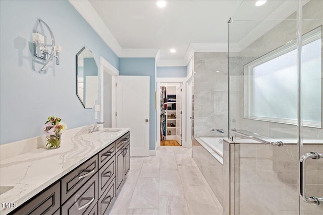 bathroom with ornamental molding, a garden tub, a walk in closet, vanity, and a shower stall