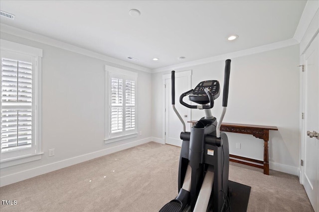 workout room featuring visible vents, crown molding, light carpet, and baseboards