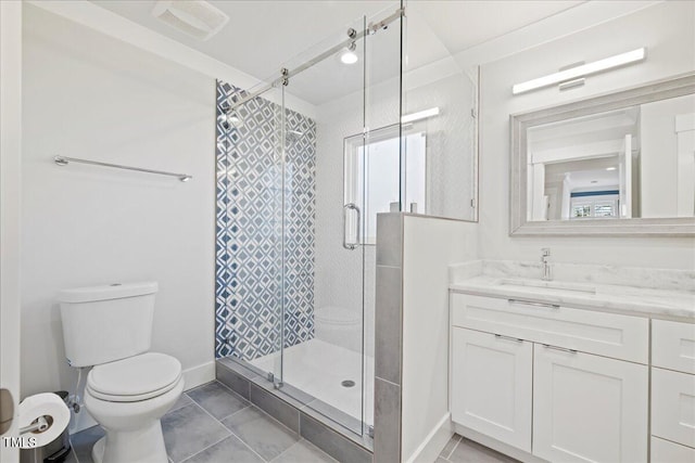 bathroom with visible vents, toilet, a stall shower, vanity, and baseboards