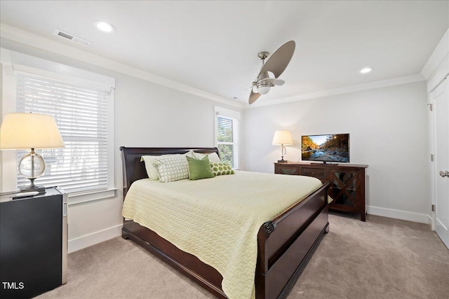 bedroom featuring crown molding, baseboards, visible vents, and light colored carpet