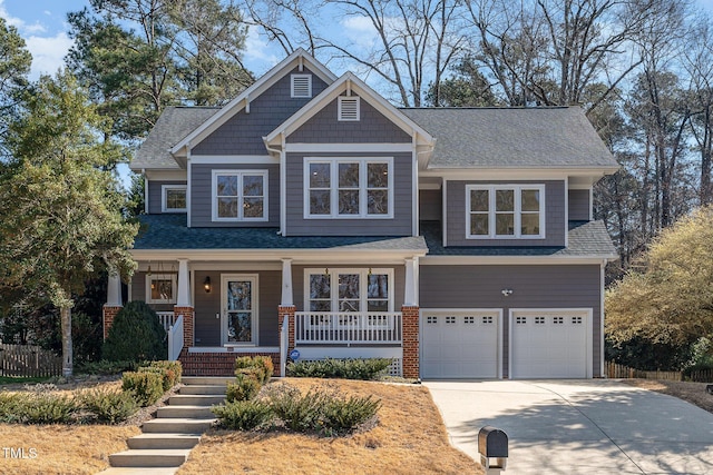 craftsman house with brick siding, a porch, concrete driveway, an attached garage, and fence