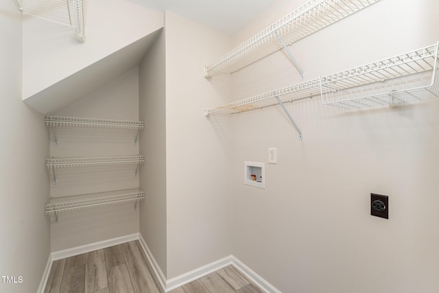 laundry area with hookup for a washing machine, light wood-type flooring, laundry area, and hookup for an electric dryer