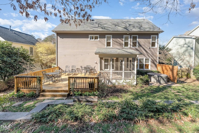 back of house with outdoor dining space, a sunroom, fence, and a wooden deck