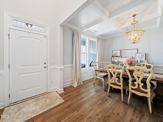 dining area with beam ceiling, ornamental molding, wood finished floors, a chandelier, and coffered ceiling