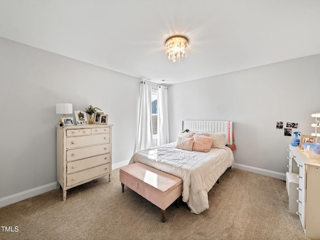 bedroom featuring light carpet and baseboards