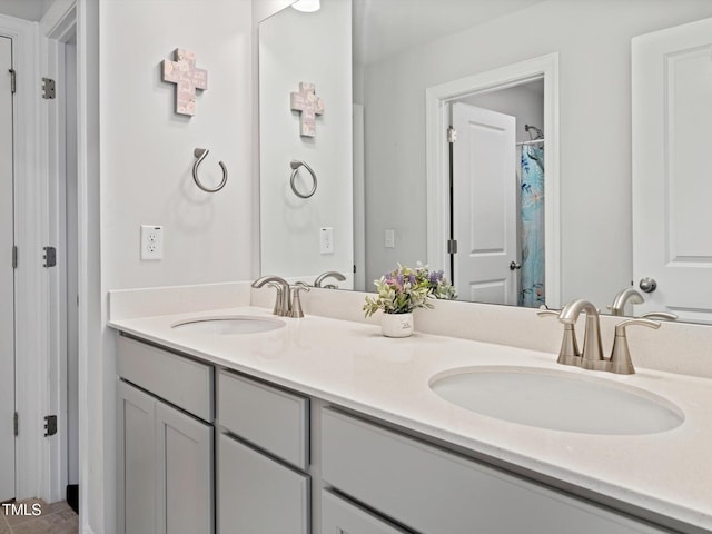 bathroom with a sink and double vanity